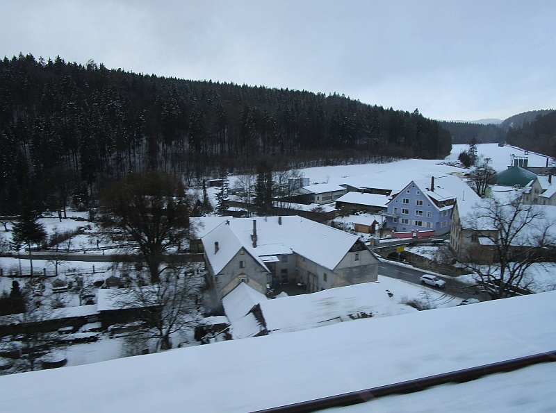 Blick aus dem Zugfenster auf die winterliche Hegaualb beim Ort Talmühle